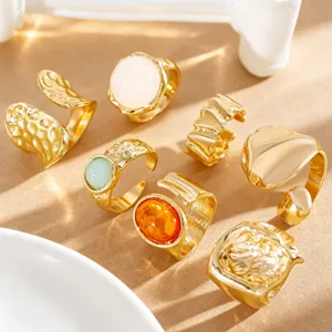 Detail shot of gold vintage Baroque rings with lava texture and colorful stone inlays.