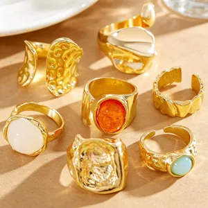 Detailed shot of vintage gold rings set featuring lava texture and colorful gemstones