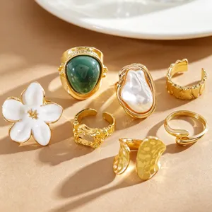Close-up of vintage Baroque pearl flower ring set with pleated lava gold metal details