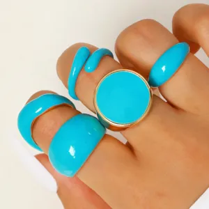 Set of vibrant blue lava-textured rings with gold-tone borders shown on a hand.
