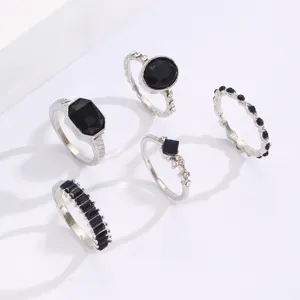 Detailed view of vintage silver-tone ring set featuring faceted black stones.