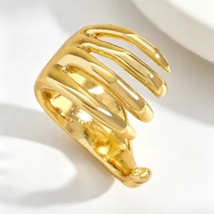 Macro view of a gold-plated skeleton hand ear cuff with punk spinal bone design details