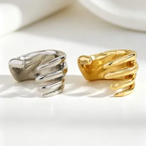 Detailed view of punk style skeleton hand ear cuffs in metallic gold and silver finishes