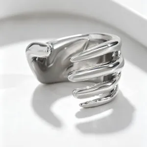 Detailed macro shot of a punk style silver skeleton hand spine bone design ear cuff earring