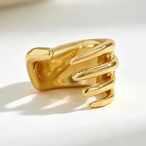 Close-up of punk style skeleton hand ear cuff with polished gold finish