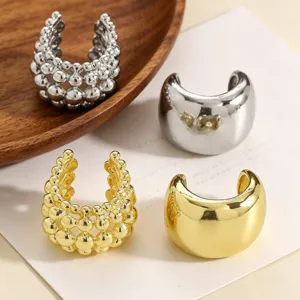 Detailed view of textured beaded and smooth polished gold and silver non-pierced ear bone clips