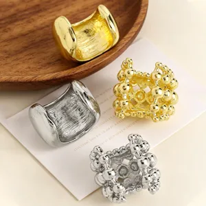 Close-up of elegant gold and silver textured and smooth ear cuffs on a display card