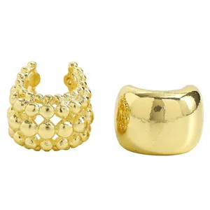Close-up detail of textured beaded mesh and polished wide band golden ear cuffs