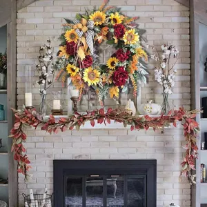 Sunflower wreath with red peonies hanging over a rustic fireplace mantle