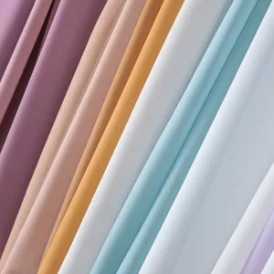 Detailed close-up of soft multi-colored chiffon hijab fabric folds in pastel tones