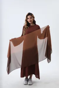 Close-up of lightweight gradient chiffon scarf in earthy brown tones for women