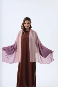 A model wearing a stylish gradient pink to purple chiffon shawl over a long brown dress