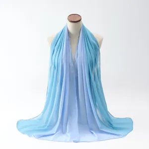 Elegant gradient light blue chiffon hijab scarf displayed on a mannequin torso detail view