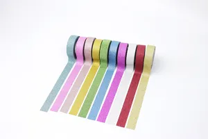 Glitter washi tape detail showing sparkling surface texture and vibrant assorted colors for crafts.