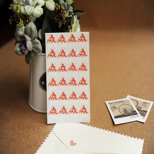 Floral photo corner stickers for scrapbooking and DIY picture frames, 24 pieces per sheet.