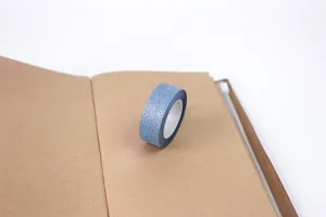 Blue glitter washi tape detail shot, perfect for DIY journaling, scrapbooking, and crafts.