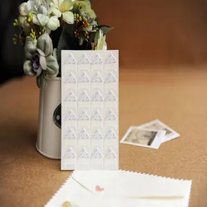 Floral photo corner stickers close up, DIY scrapbooking stationery details, picture tabs