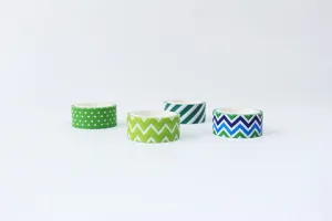 Colorful washi tape detail showing various green and blue geometric patterns for DIY crafts.