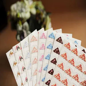 Floral photo corner stickers detail showing assorted pattern designs for DIY scrapbooking album.