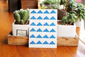 Blue polka dot photo corner stickers for DIY scrapbooks and photo albums, detail view.
