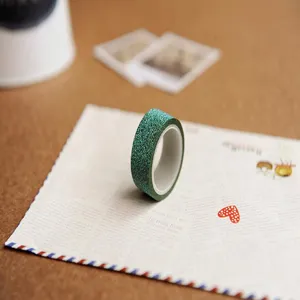 Close-up of green glitter washi tape showcasing sparkling texture and details for DIY journaling.