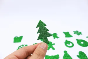 Detail shot of green glitter EVA Christmas tree sticker, sparkly festive craft supply.