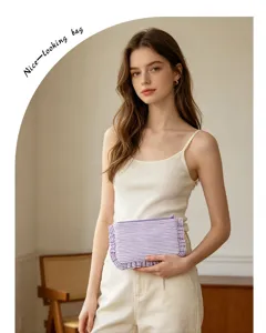 Portable striped cosmetic bag with cute ruffle trim, stylish travel clutch for women.