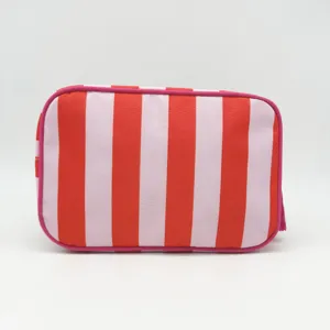 Detailed closeup view of the red and white striped makeup pouch, showing zipper detail.