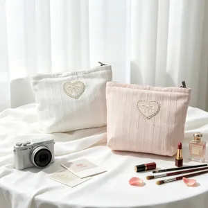 Detailed view of cute heart bow cosmetic pouch, fabric texture and delicate lace trim.