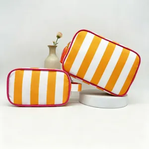 Striped cosmetic bag with tassel, waterproof travel makeup pouch and large capacity storage organizer.