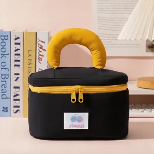 Black cosmetic bag with yellow arch handle and zipper, portable travel makeup pouch for daily use.