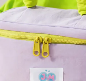 Close up of purple cosmetic bag zipper detail, portable makeup pouch storage details.