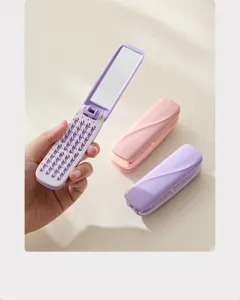 Portable folding hair brush with built-in mirror, mini travel comb for daily hair styling.