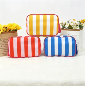 Colorful striped cosmetic bag with tassel, large capacity waterproof travel toiletry storage pouch.
