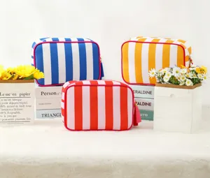 Waterproof striped cosmetic bag with tassel, large capacity travel toiletry organizer pouch.