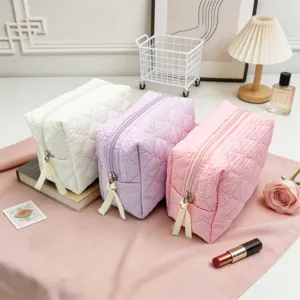 Travel cosmetic bag set, large capacity quilted makeup pouch with zip closure and ribbon pulls.