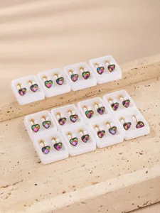 Detail shot of stainless steel rhinestone heart ear clip converters in white display boxes.