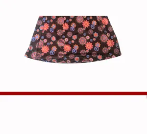 Retro 60s hippie dress detail featuring colorful floral peace sign print on dark fabric.