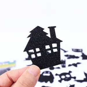 Close-up of black glitter EVA haunted house sticker for Halloween crafts and decor.