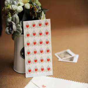 Paper photo corner stickers with red heart design for DIY photo albums handmade scrapbooking.