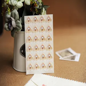 Close up of cartoon monkey paper photo corner stickers for DIY scrapbook crafting detail.