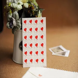 DIY photo album corner stickers paper red heart shape craft decoration detail close-up view