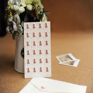 Detailed close-up of cute cartoon monkey paper photo corner stickers for DIY handmade photo albums.