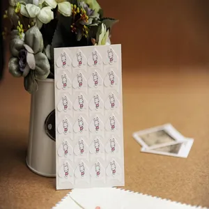 Paper photo corner stickers with cartoon rabbit design for DIY album craft details.