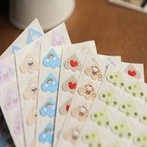 Close-up detail of colorful cartoon photo corner stickers for DIY handmade photo albums.
