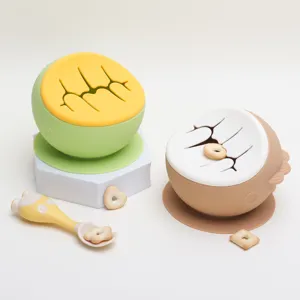 Silicone baby snack bowl with suction base and spill proof lid for toddler self feeding training.