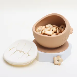 Silicone baby snack bowl detail view showing suction base and slit lid design for kids.