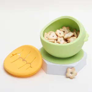 Silicone baby snack bowl detail view with suction base and soft petal lid for toddler feeding.