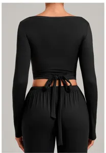 Black long sleeve yoga top detail, featuring wrap tie back design for women fitness.