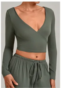 Deep green long sleeve wrap crop top and matching drawstring pants for active fitness yoga.